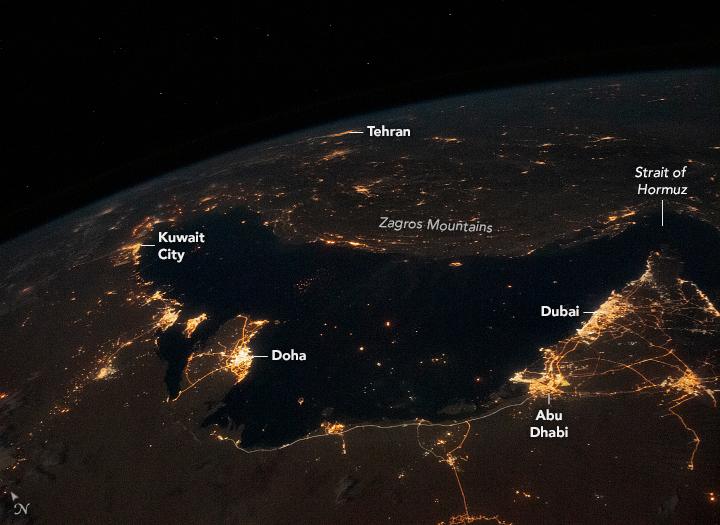 City lights surround the Persian Gulf