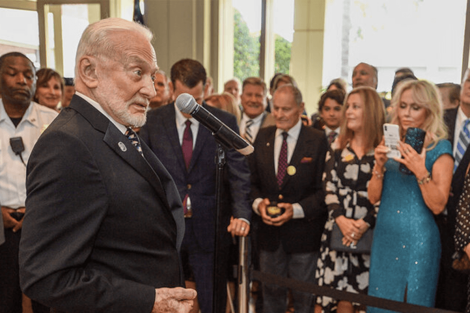Buzz Aldrin get animated as he talks about the United States returning to the Moon after touring the Apollo 11