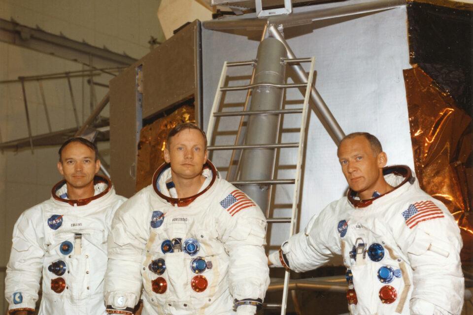 Apollo 11 astronauts in front of lunar module mockup