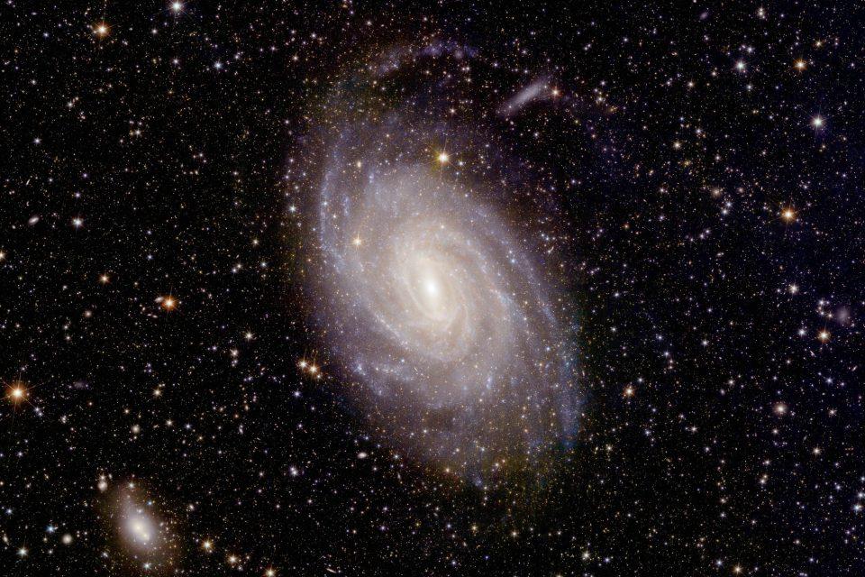 Young stars illuminate a spiral galaxy in the constellation Pavo